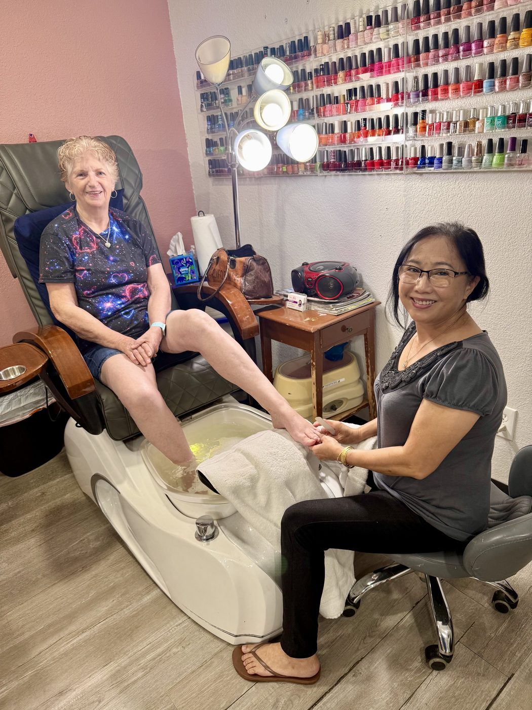 Christina's mom giving a pedicure at the nail salon where she works