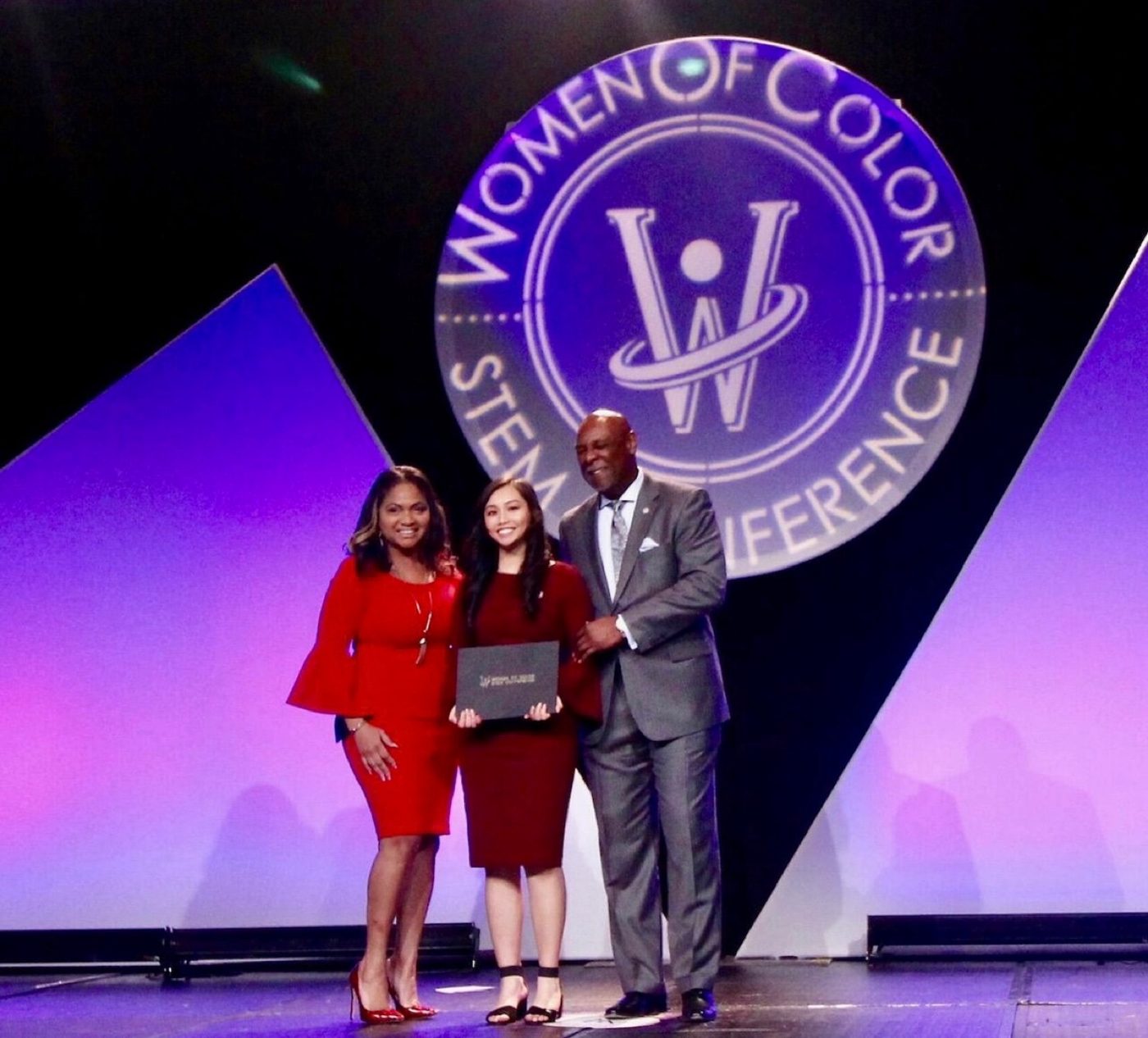 Christina receiving the Technology Rising Star Award from Women of Color STEM Magazine